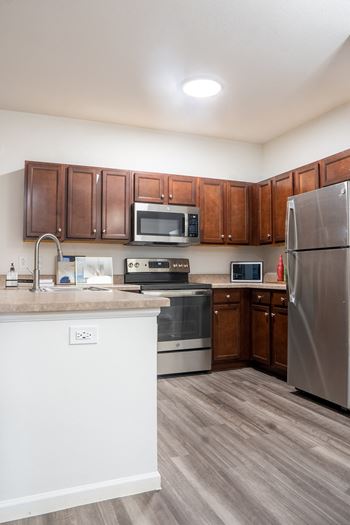 Kitchen with wooden cabinets and stainless steel appliances
